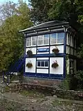 Chesham signal box in 2008, with a sign "CHESHAM" not in the TfL standard Johnston typeface