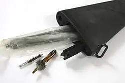 Storage compartment inside a buttstock with opened trapdoor