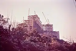 Construction site with cranes and partially built concrete structure