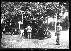 Cars stopped by an infantry picket (territorials in uniform) on a main road.