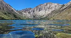 View across Convict Lake, towards Sevehah Cliff in the background