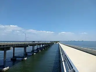 View towards east (Tampa) from pedestrian trail bridge of the largest water channel cutting through the causeway