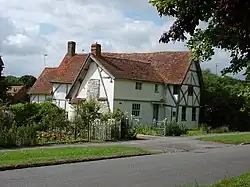 39 The Causeway is a late 14th-century timber-framed house, extended in the 15th and 17th centuries. It is Grade II* listed.[24] A cruck frame and an external bread oven are visible in the gable wall nearest the camera.