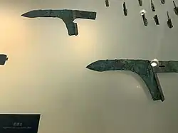 Two dagger axe heads and numerous small arrowheads