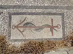 A mosaic with a dolphin and anchor design