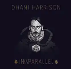 A black-haired, Caucasian man's face on a black background. All text on the cover is gold. Above his head are the words "DHANI HARRISON", and below reads "IN///PARALLEL", surrounded by what appear to be two pine cones.