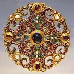 The Dorestad Brooch, c. 800, found in the Netherlands. Gold, pearls, with cloisonné almandine, enamel, and glass.