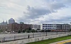 Looking at the Dorothy Day campus from across a freeway. Pictured are three buildings, two modern, one ca.1920.