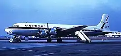 A United Airlines Douglas DC-7 four-prop airliner on an airport tarmac