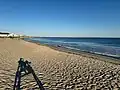 View of East Matunuck State Beach looking east from the first lifeguard chair. It shows the houses on the east end of the beach and the breakwater.