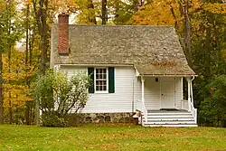 Photograph of the East Middle Patent Schoolhouse on a partly cloudy day in the Fall