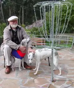Headrick with his two whippets with a new DGA disc golf lightweight all metal disc golf target. Photo taken in 2002 two months before he died