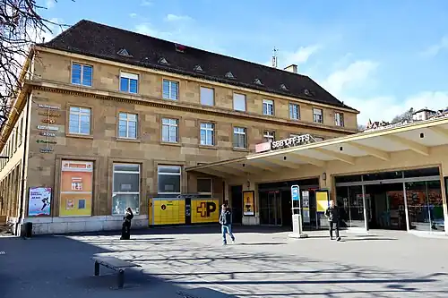 Large four-story stone building with hip roof