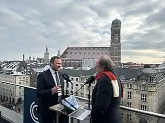 Estonian official being interviewed by Monocle Radio at the 2025 Munich Security Conference