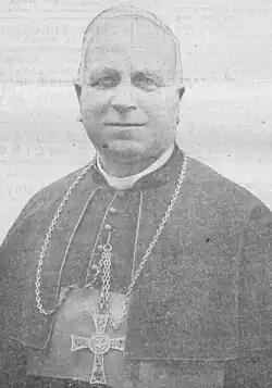 Newspaper clipping: black and white photograph of mature white man, dressed in an archbishop's gown.