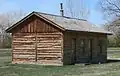 A reconstruction of the Fort Robinson adjutant office in Nebraska has corner post construction with log infill.