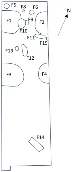 Approximately rectangular shape with fourteen features of various shapes marked, mostly in the northern half