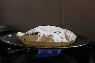A roti being baked on a tava