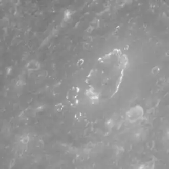 View of Geddes at a high sun angle, where the hollows are visible as bright spots