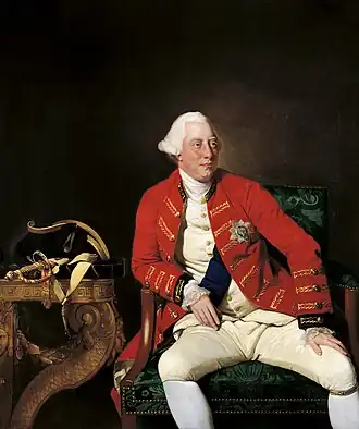 Three-quarter length seated portrait of a clean-shaven George with a fleshy face and white eyebrows wearing a powdered wig.