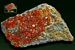 Spessartine garnet on feldspar - Tongbei Yun-xiao, Fujian, China.