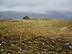 Summit cairn and remains of a Bronze Age tumulus on the summit of Great Mell Fell
