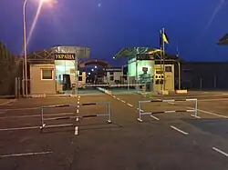 The pedestrian border crossing between Veľké Slemence, Slovakia and Mali Selmentsi, Ukraine as seen from Ukrainian side of the border, June 2017, night time.