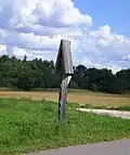 A roofed pole in Griniai, next to a road to Kupsčiai