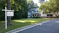 White house with a sign in the front reading "Union-Philanthropic Literary Society"