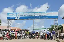 A sign saying "Welcome to Hồng Ngự District"