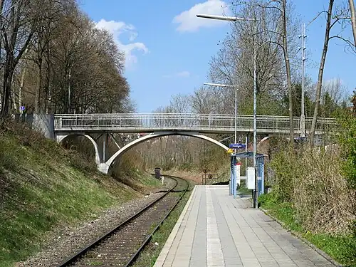 Platform next to railway line beneath a bridge