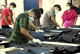 Hand scraping of jeans