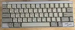 The image shows a well-used, first-generation Happy Hacking Keyboard.
