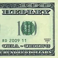 A half-image of a US $100 bill that features the band's name and song title.