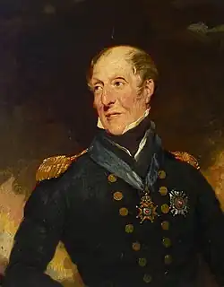 Half-length portrait of a man looking over his shoulder. His hair is sparse and balding, and he wears a dark blue jacket with epaulettes and gold buttons, with a blue sash collar around his neck, suspended from which is a medal.