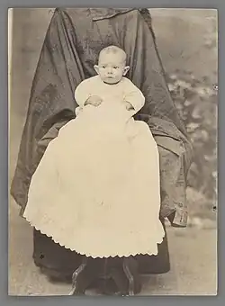 Mother well hidden by long overcoat​​‌