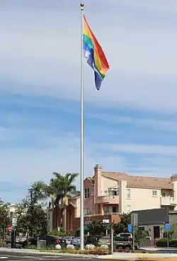 Rainbow flag on a tall flagpole