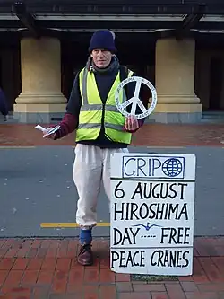 An anti-nuclear activist hands out peace cranes in Wellington. New Zealand's foreign policy is often symbolised by its anti-nuclear stance.