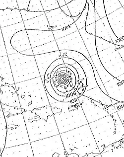 A drawn weather map of Hurricane Dog. The storm is depicted to be north of Puerto Rico. The eastern tip of North Carolina is seen in the top-left portion of the map.