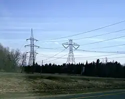 450&nbsp;kV HVDC line (at right), on south side of Autoroute 20 east of the Nicolet station near Sainte-Eulalie, Quebec.