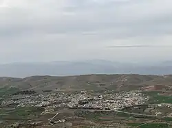 Mangesh village in the Kurdistan Region of Iraq, surrounded by hills and farmland.