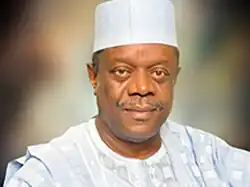 Idongesit Nkanga wearing a traditional cap