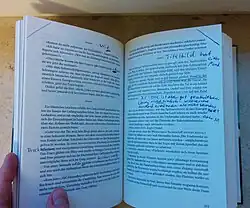 Photograph of a German novel, Infinite Adventures, which uses an infinity symbol in triplicate as a dinkus.