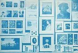Photograph of a wall covered in photographs