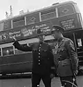 An officer of the Royal Netherlands Army asks directions from a Metropolitan Police officer in London, 1942. The police officer's tunic is of an obsolete design.