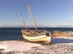 The replica of James Caird at the Museo Nao Victoria in winter with snow.