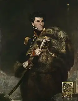 A man in ceremonial naval uniform looks right, gaping a large sword in his right hand. A navigational instrument stands on a table, lower right.