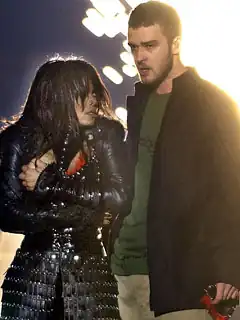 Jackson, clutching her exposed right breast with her left hand, looking at Timberlake, who is standing next to her.