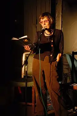 Photographic portrait of Jehane Markham reading her poetry
