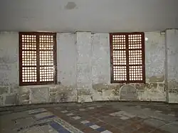 Gravestones beneath capiz shell windows
